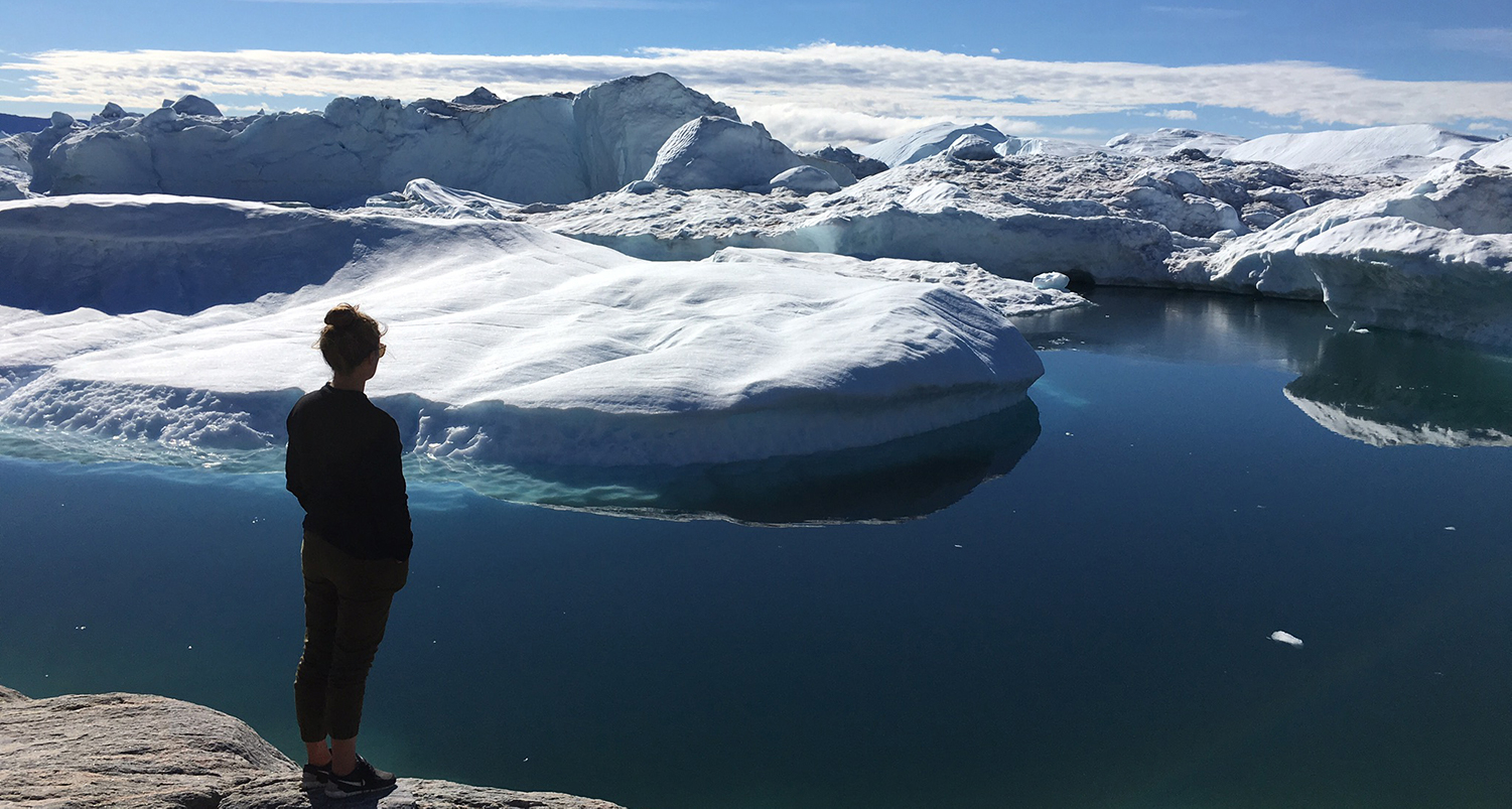 Sarah Glenn overlooking glacier and water.